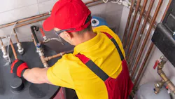 plumber servicing a commercial water heater plumber servicing a commercial water heater
