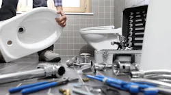 plumber installing a toilet