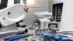 plumber installing a toilet plumber installing a toilet