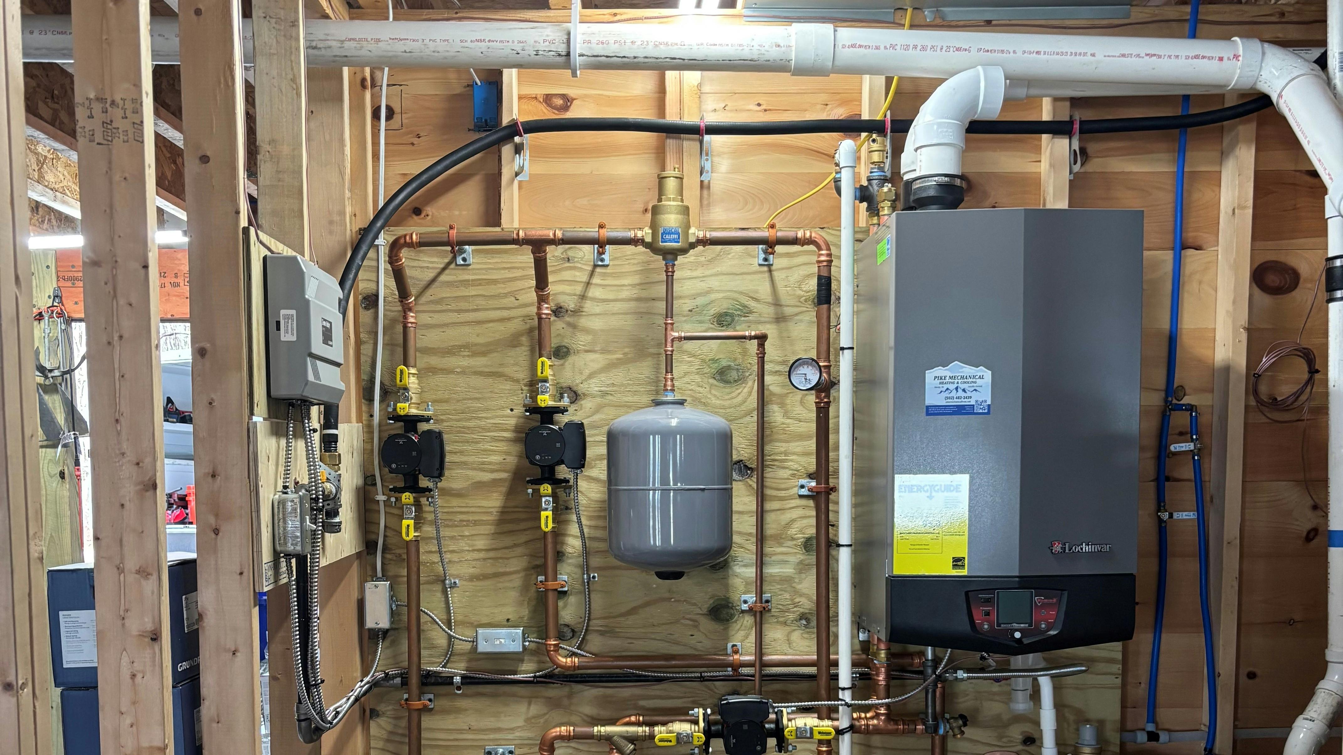 The wall-hung boiler with circulators, venting and expansion tank.