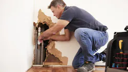 Plumber fixing burst pipe Plumber fixing burst pipe