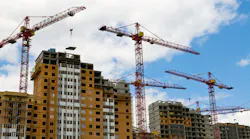 Construction cranes on a job site.