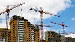 Construction cranes on a job site.