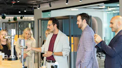 Francisco Barboza Grasa (center), a Spanish designer and engineer and Senior Design Manager – Product & Transportation for Pininfarina of America, discusses flushometers.