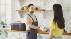 friendly plumber with satisfied client