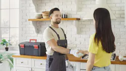 friendly plumber with satisfied client