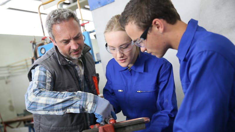 Master plumber with apprentices.