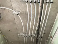 Piping at the Urby Dallas Luxury Apartments in Dallas, TX. 27 stories, 388 Units. The project used Uponor on DHW/DCW risers and mains and in-suite plumbing 3' and down.