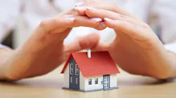 hands protecting a home