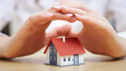 hands protecting a home