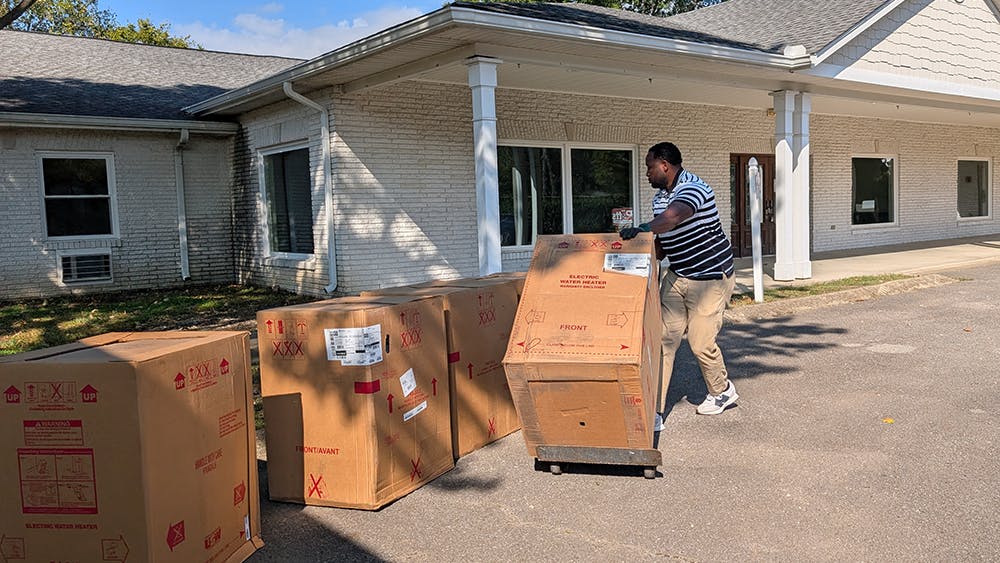 New water heaters being delivered to one of Shelter Equity's group homes.
