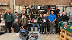 Instructors and students in the HVAC and hydronics classroom at Red Rocks Community College, with the new training board in the background.