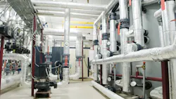 modern gas boiler room with manometers, valves, pumps and thermo-insulation on pipelines