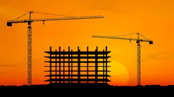 construction cranes at sunset