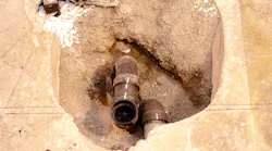 Exposed plumbing pipes under a concrete slab