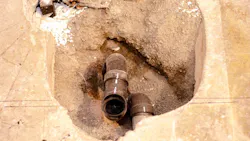 Exposed plumbing pipes under a concrete slab