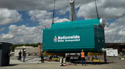 A boiler being crane-lifed.