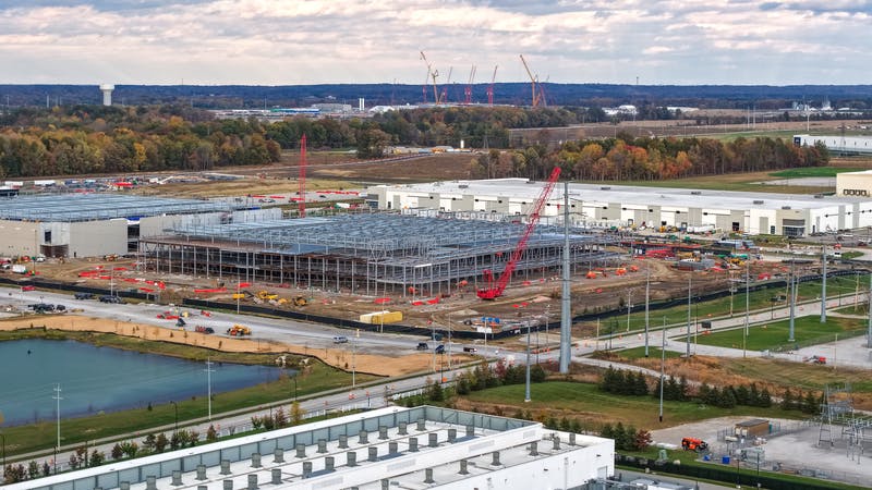 Industrial Data center construction site with cranes erecting a new building frame