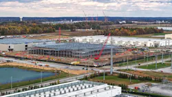 Industrial Data center construction site with cranes erecting a new building frame