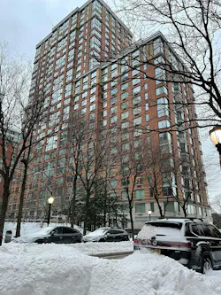 Exterior of 212 Warren Street from with snow (rear of the building, the front faces the river).