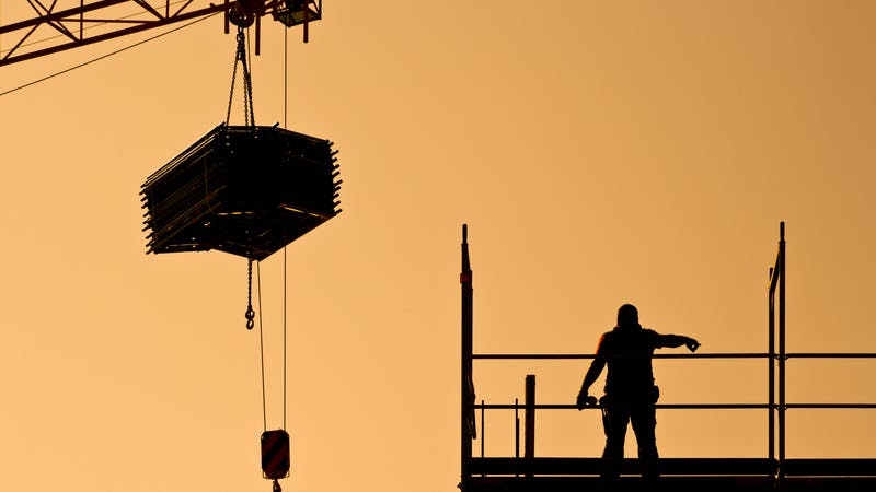 construction worker directing crane