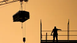 construction worker directing crane