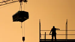 construction worker directing crane