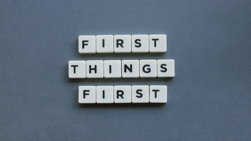 First Things First against a gray background