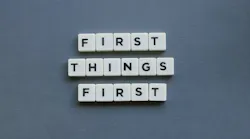 First Things First against a gray background