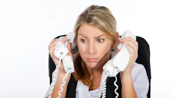 stressed office worker answering too many phones