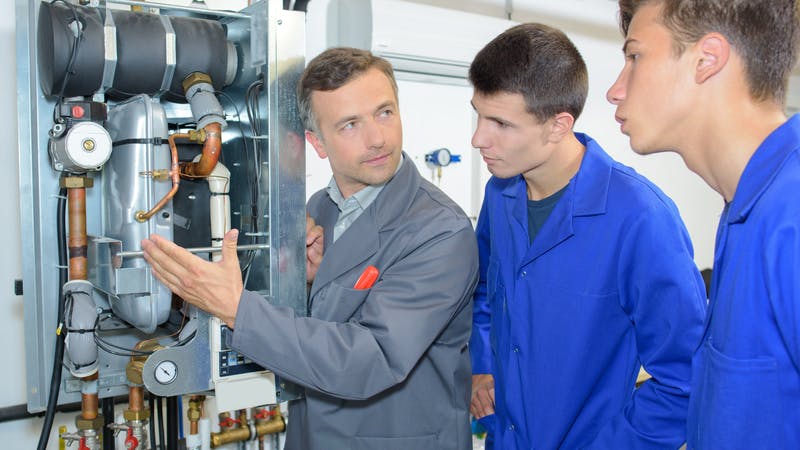 Sr. technician explaining a boiler to apprentices