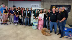 Students, technicians, and build mentor Keaton Lee pose for a photo.