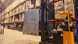 forklift driver moving building supply materials in a warehouse