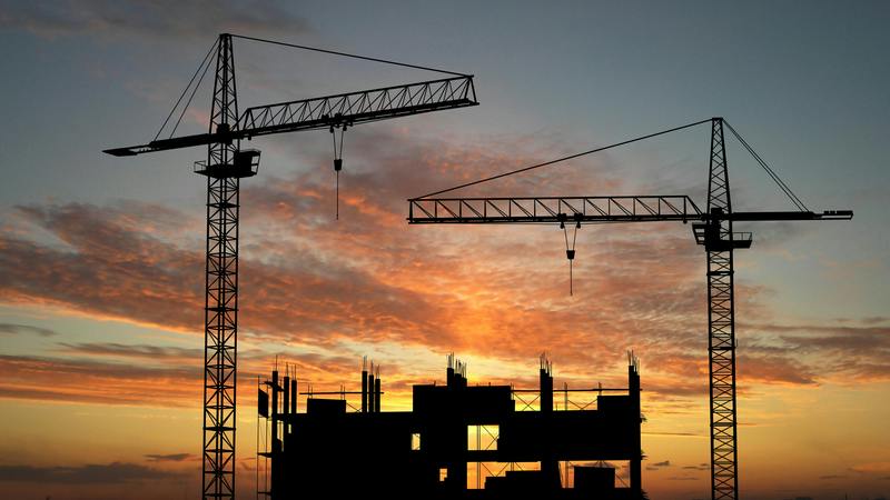 construction cranes at sunset