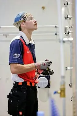 Charles Goede competes during the plumbing competition.