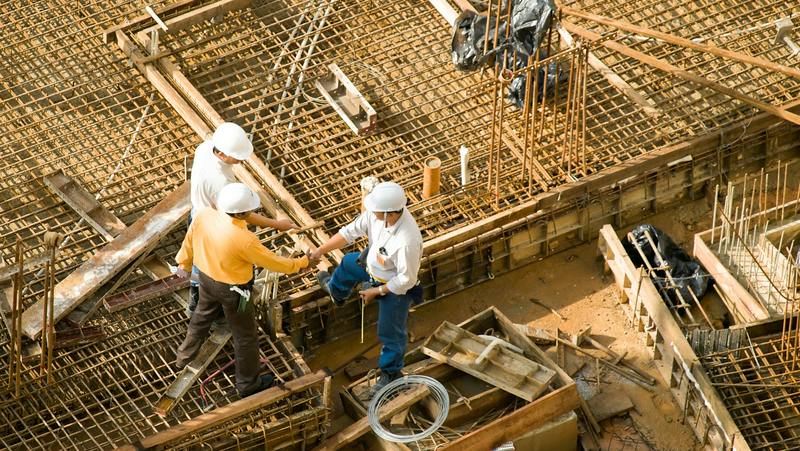 workers shaking hands on a construction site
