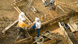 workers shaking hands on a construction site