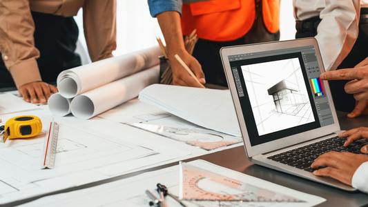 Engineer and architect using architect designing software together.