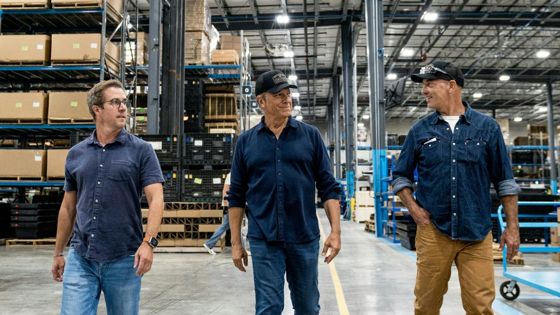 Mike Rowe (center) tours DECKED's Defiance, OH facility.