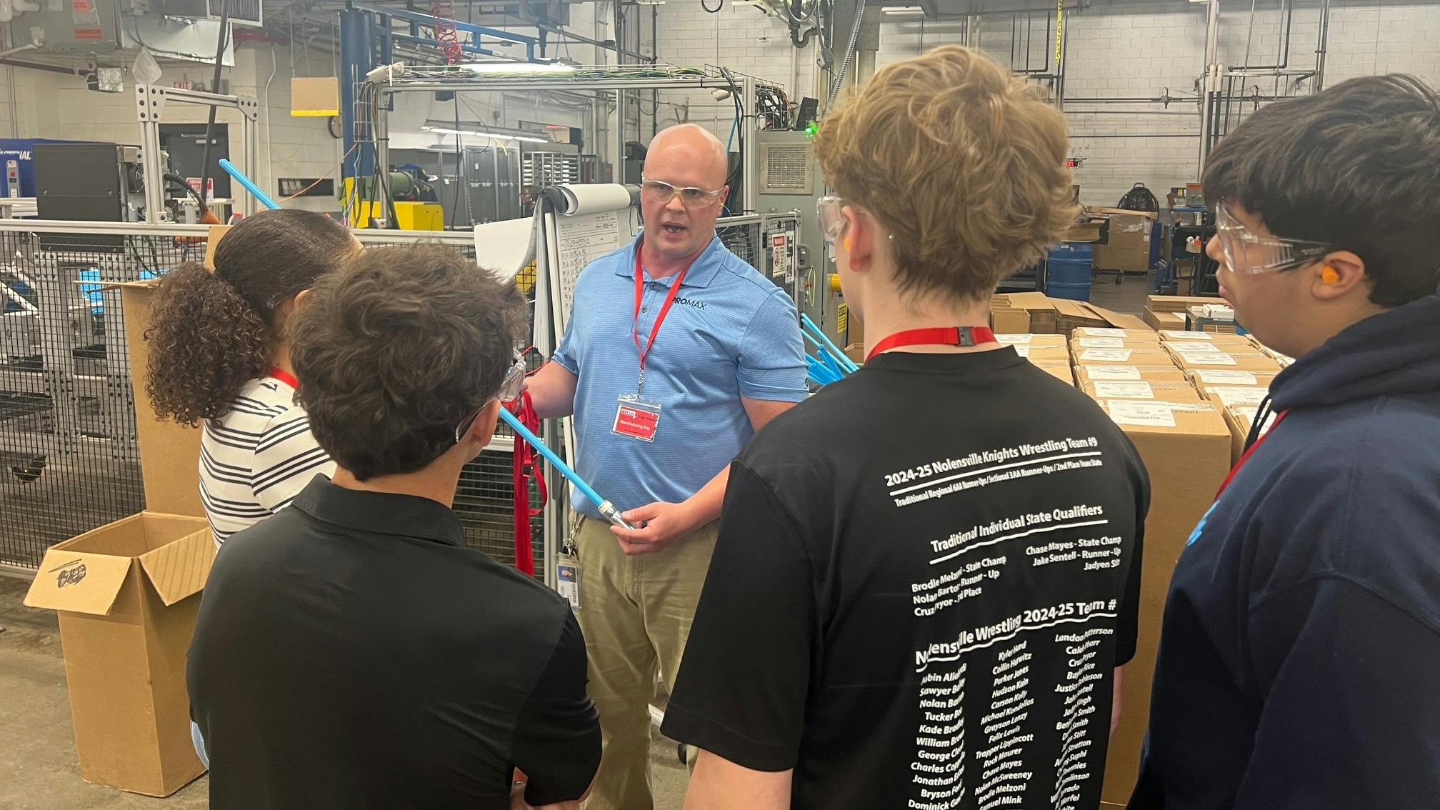 High school students on the APCOM facility tour learn what a dip tube is and how it works.