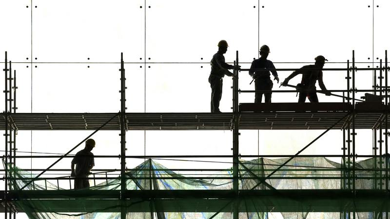 group of construction workers on scaffolding