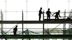 group of construction workers on scaffolding