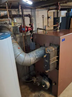 The old boiler. Note the black box in front of the vent stack.