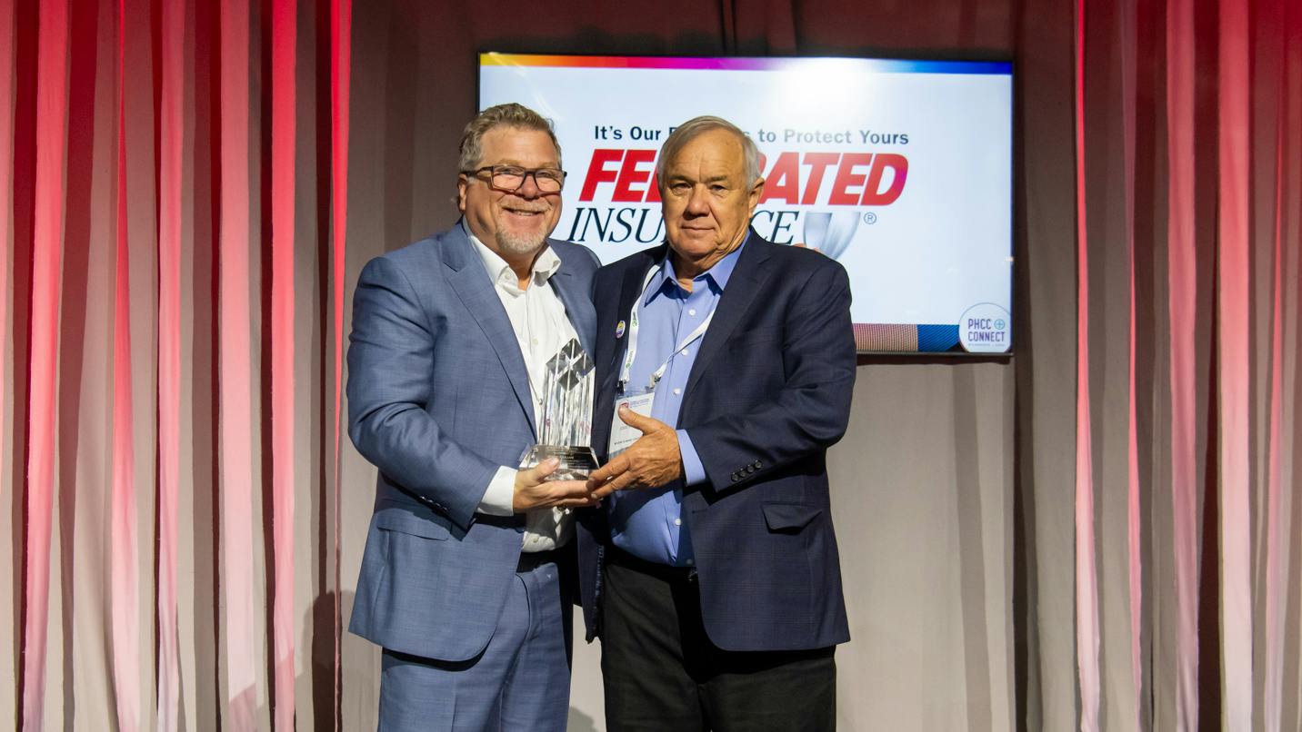 PHCC President Jason Pritchard presents the George D. Scott Award&mdash;the Association's highest honor&mdash;to Eddie Hollub, president of Modern Plumbing and Air Conditioning, Pasadena, Texas.